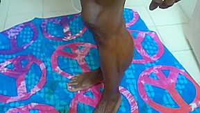 Extremely muscular ebony getting ready