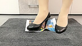 Girl trampling crushing paper in black high heels