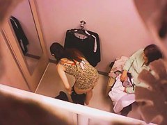 Goog looking girl choosing some underwear in a changing room