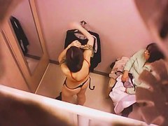 Goog looking girl choosing some underwear in a changing room