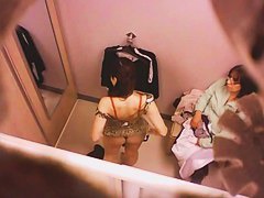 Goog looking girl choosing some underwear in a changing room