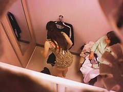 Goog looking girl choosing some underwear in a changing room