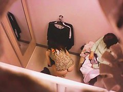 Goog looking girl choosing some underwear in a changing room