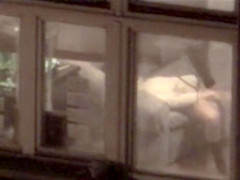 Lovely babe filmed masturbating through apartment window