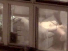 Lovely babe filmed masturbating through apartment window