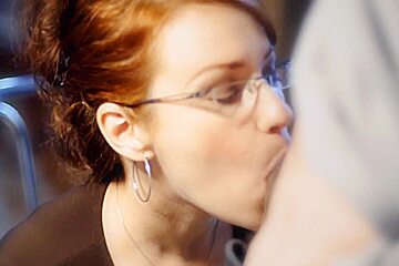 Redhead with really big bosoms does a sensual blowjob
