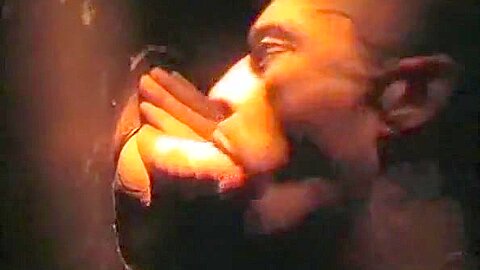 Sucking cock at a gloryhole