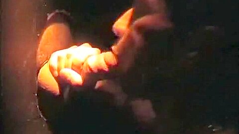 Sucking cock at a gloryhole
