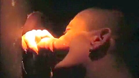 Sucking cock at a gloryhole