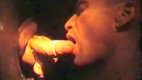 Sucking cock at a gloryhole