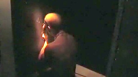 Sucking cock at a gloryhole